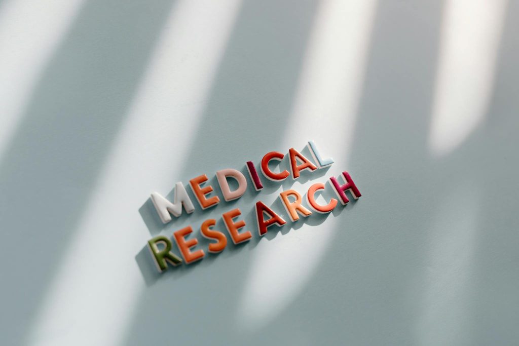 Creative representation of medical research with colorful letters and shadows.